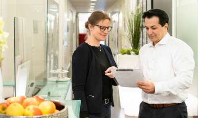 Zwei Personen besprechen Dokumente in Büroeinrichtung.